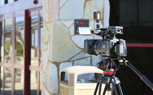 Television news camera on a tripod outside the airport entrance