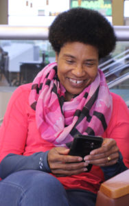 Smiling woman holding a mobile phone